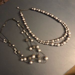 Set of two necklaces.  Gray in color.  One is triple strand and the other is two